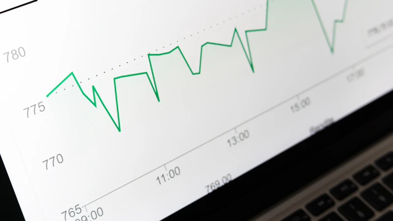 stock market chart displayed on laptop screen
