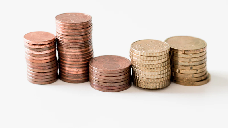 stacked round gold-colored coins on white surface