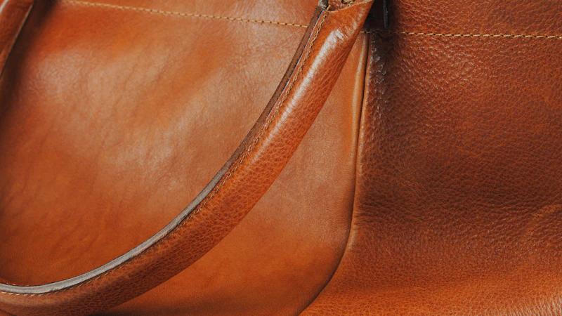 a brown leather handbag with a long strap