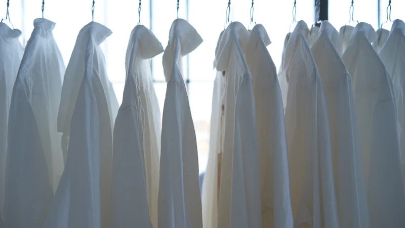 white dress shirt hangign on clothes