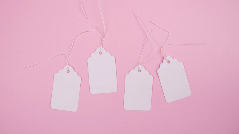 white apple earpods on pink surface