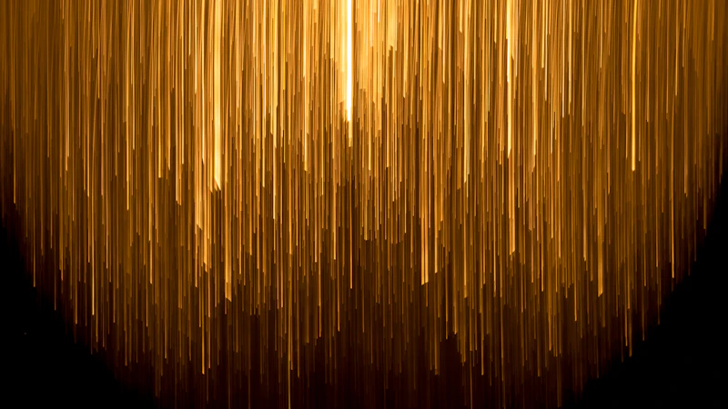 a very long line of yellow lines on a black background