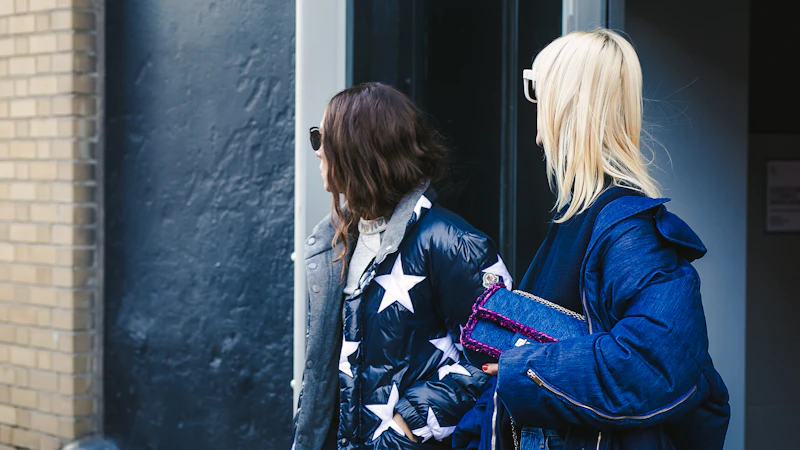 man and woman standing in front of building wearing jackets