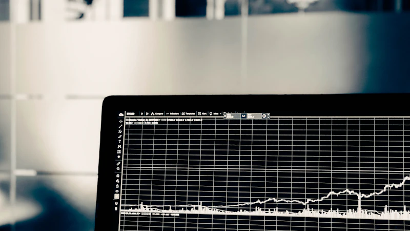 A computer screen displaying a white line graph of financial market data