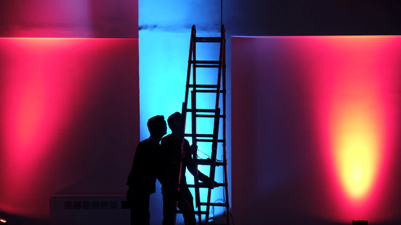 man in black jacket standing on black ladder