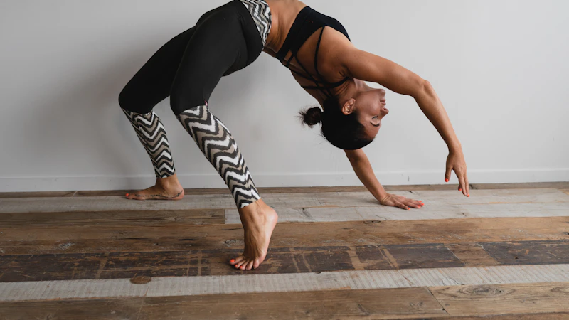 woman bending backwards beside wall