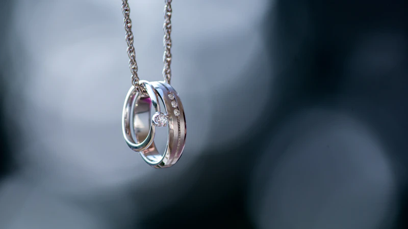 silver-colored ring pendant