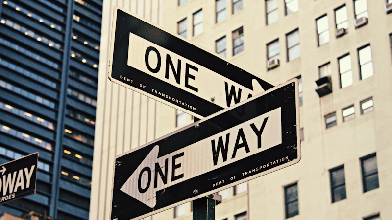 white and black One Way-printed road signages