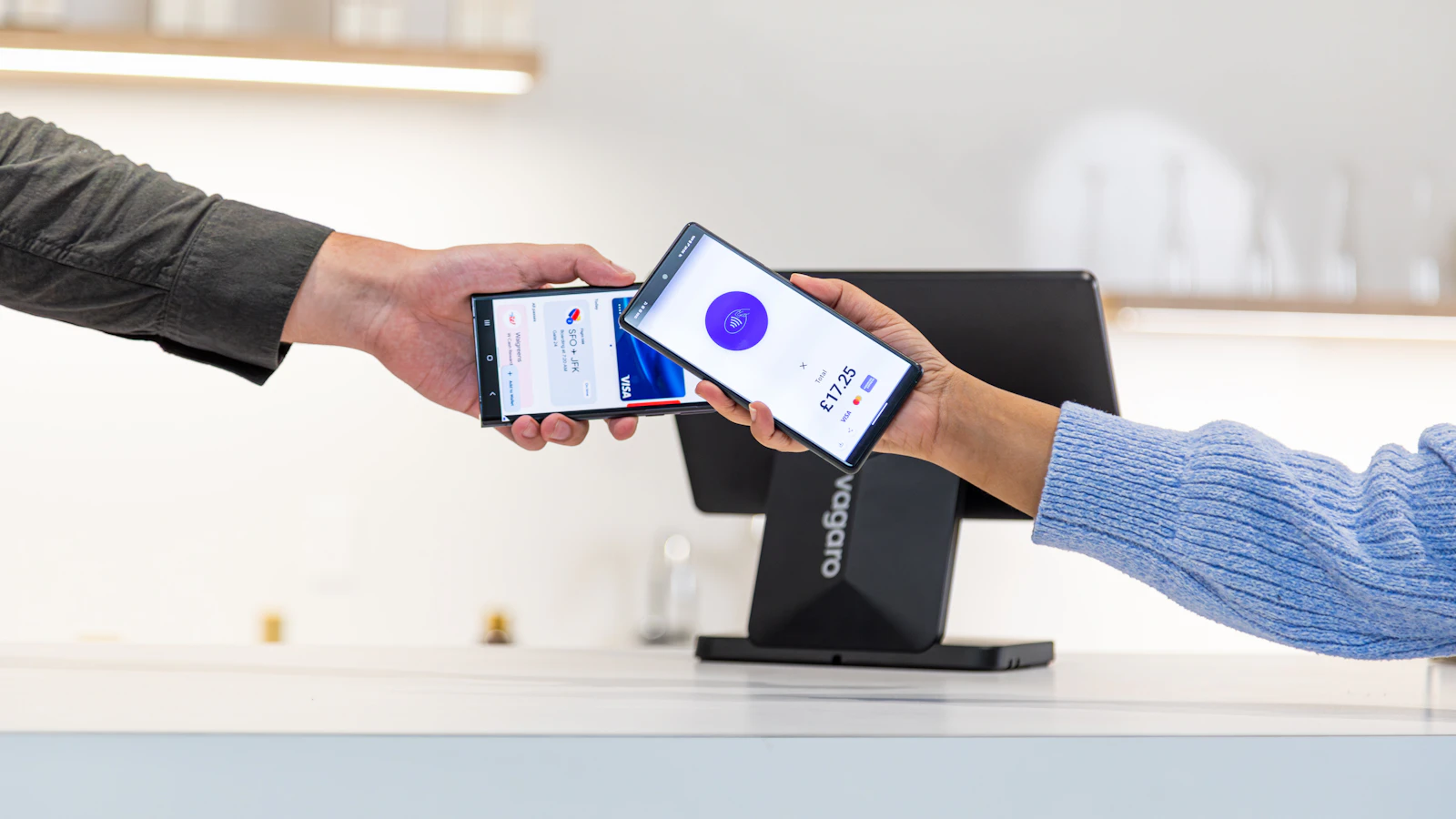 Customer paying with smartphone at point of sale terminal