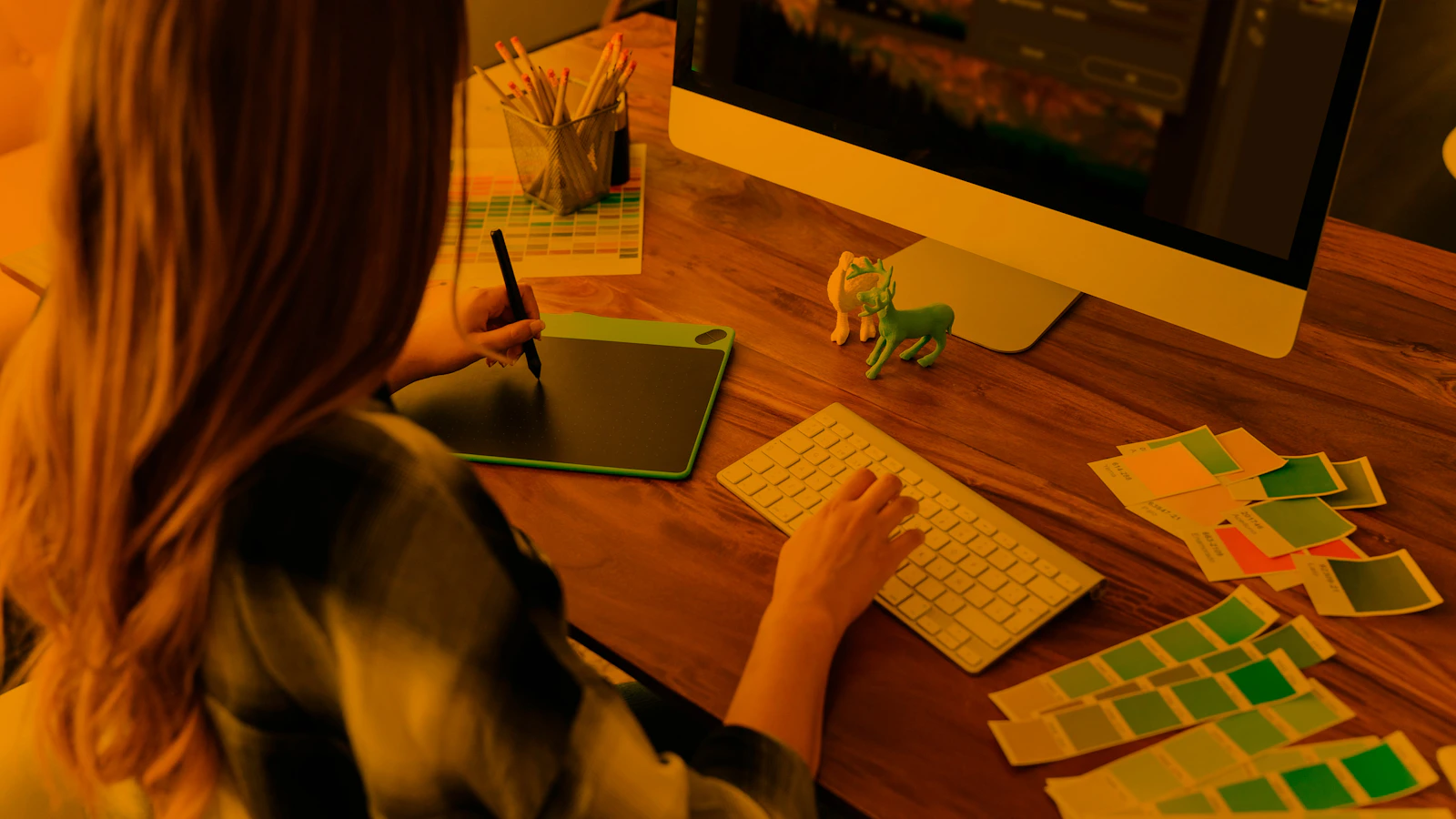 a woman sitting at a desk using a computer
