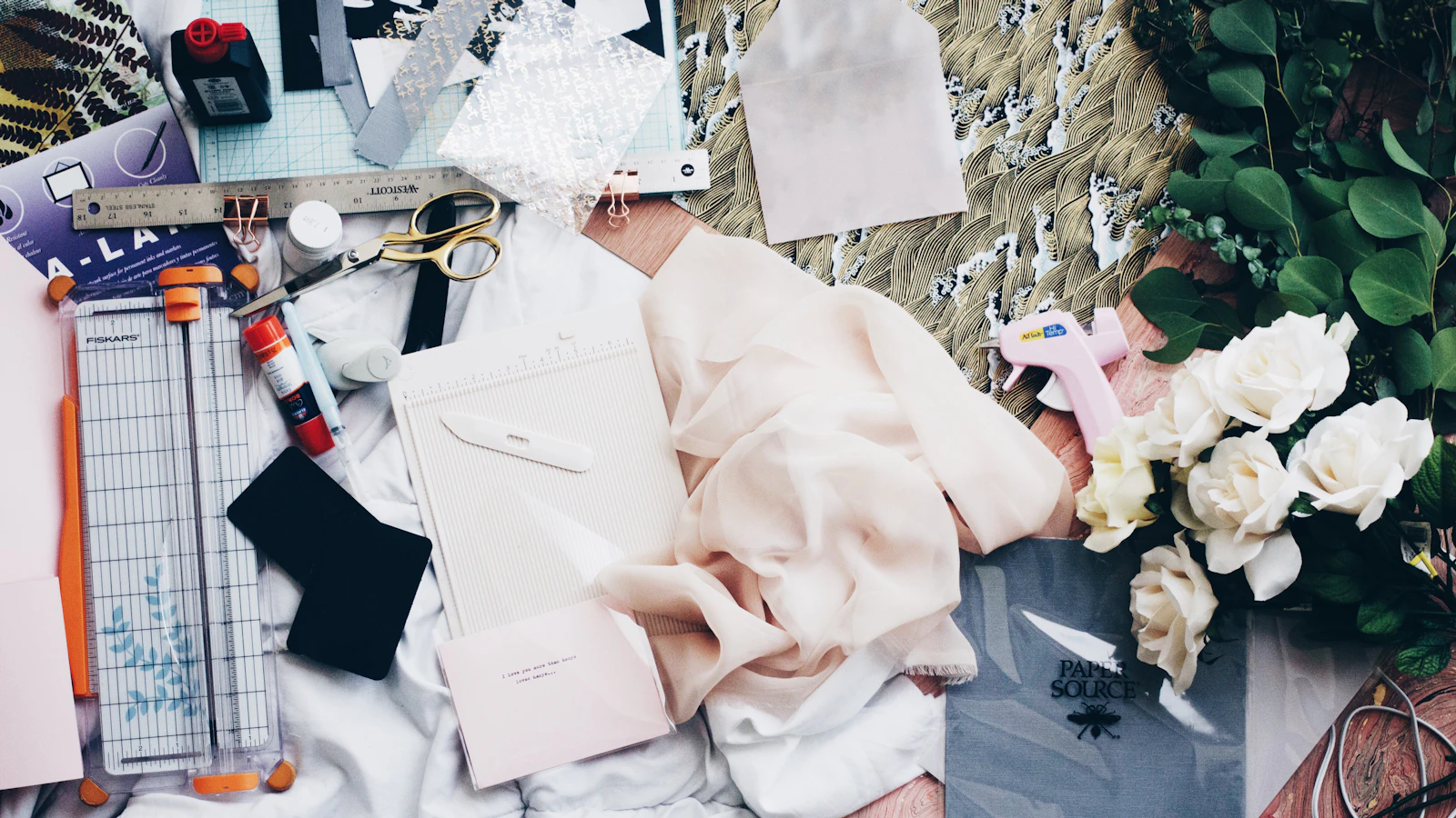 papers beside shears and paper cutter