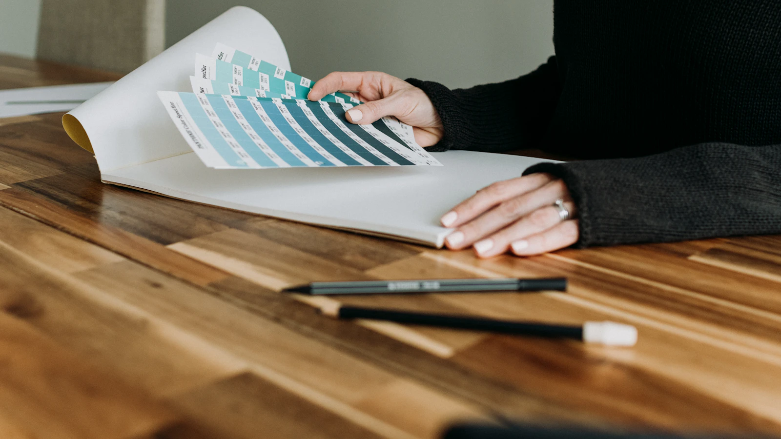 a person sitting at a table working on a project