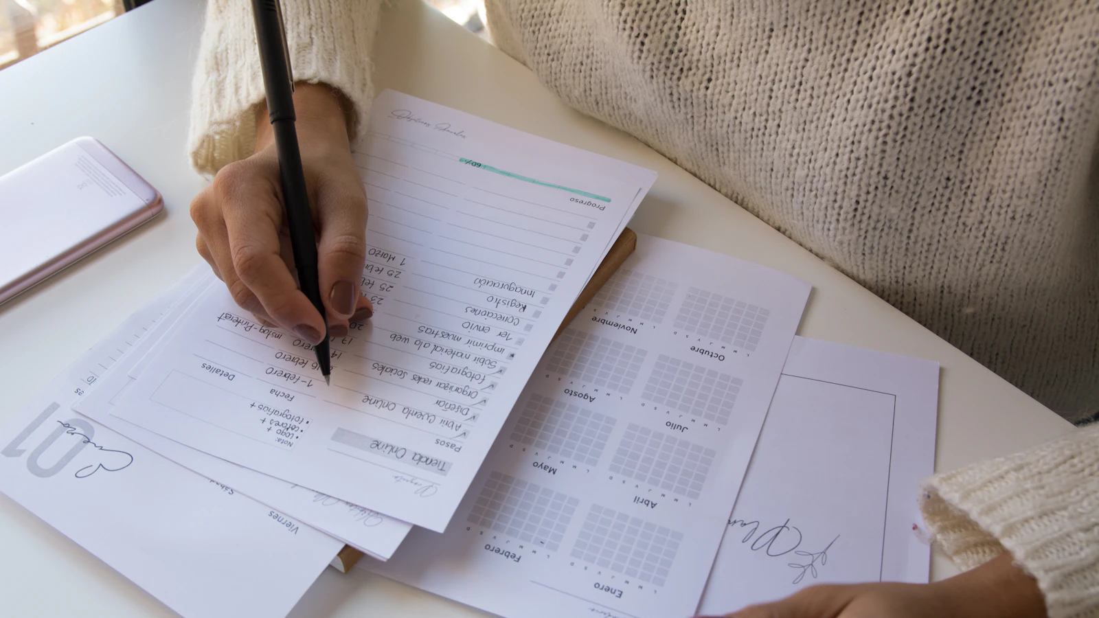 person writing on white paper