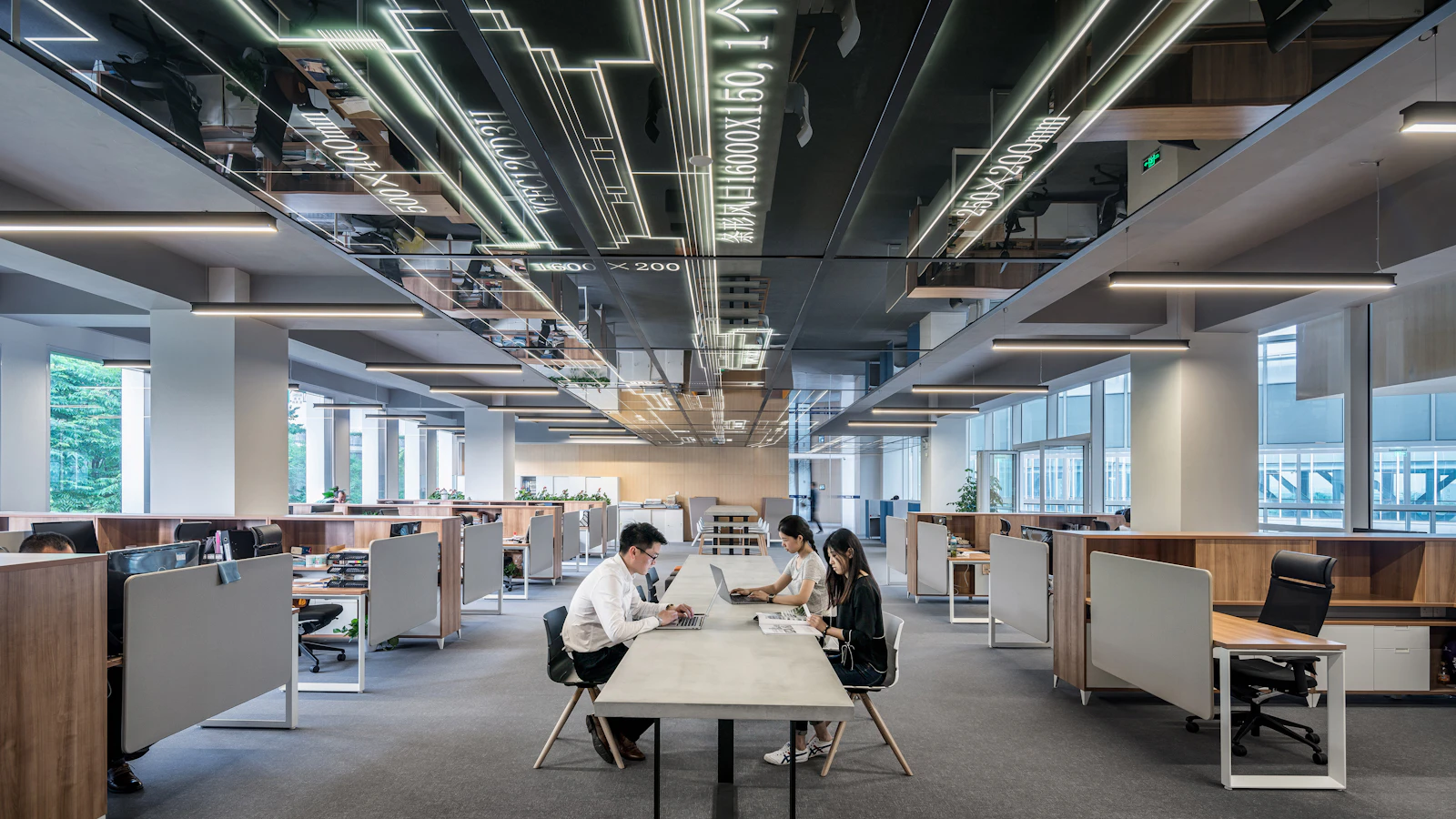 three people collaborating in open office