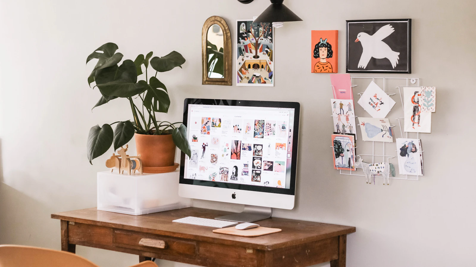 silver iMac on wooden desk