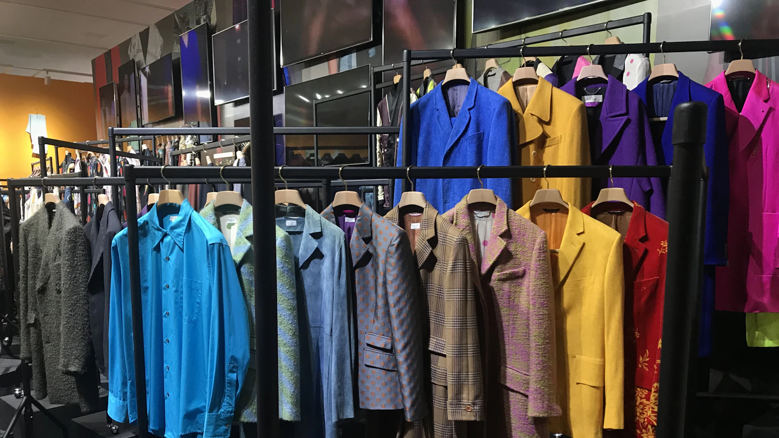 clothes hanging on black wooden rack