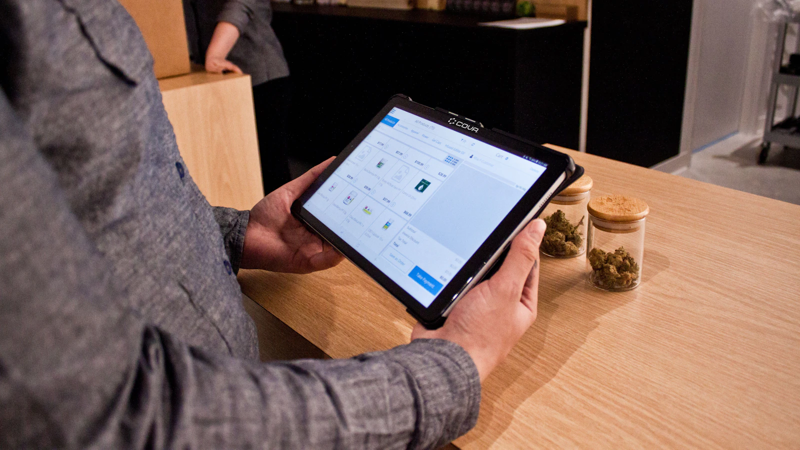 a person sitting at a table with a tablet