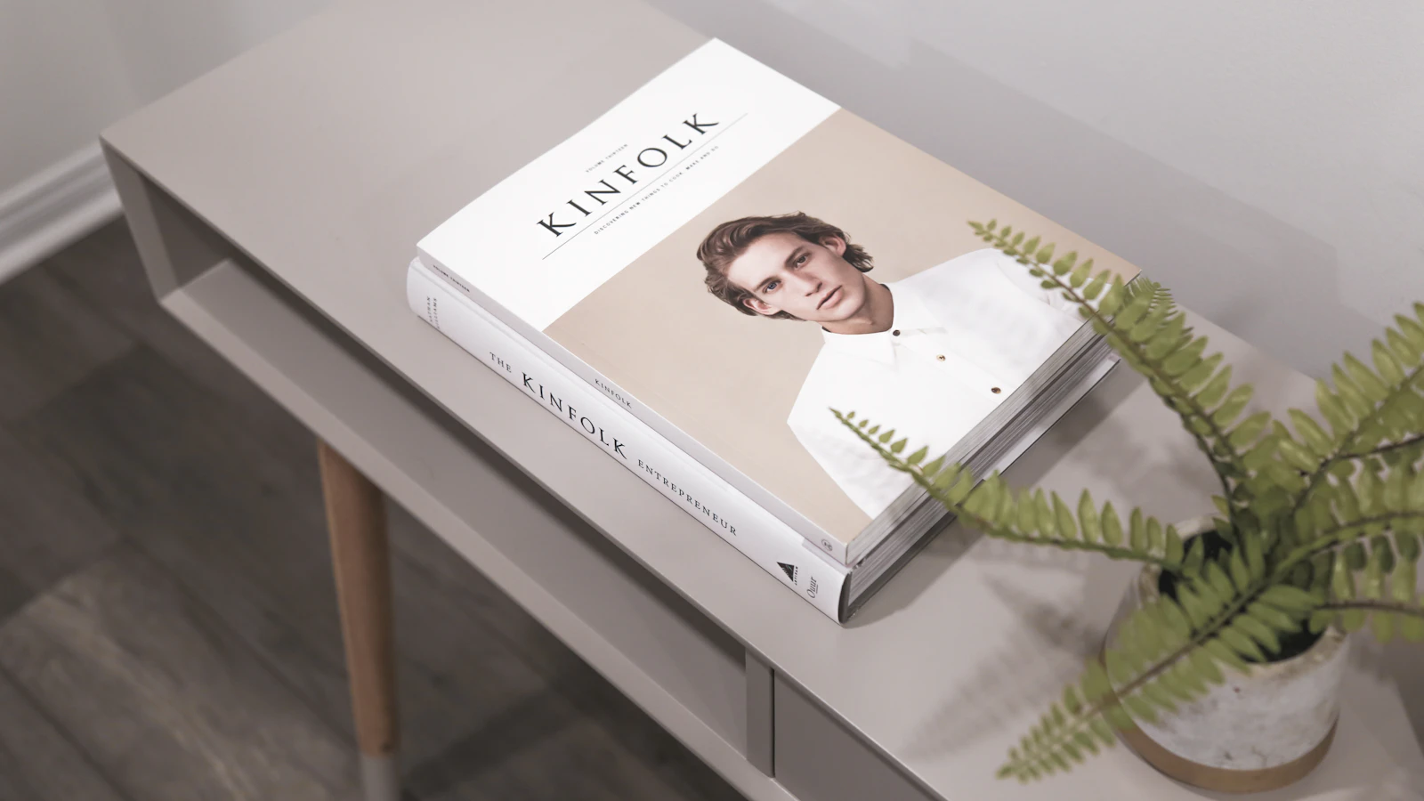 Kinfolk smartphone book on gray wooden side table