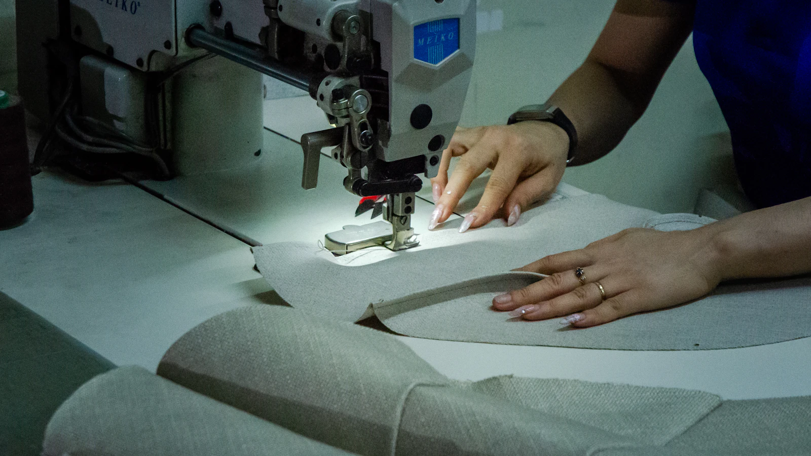 A woman using a sewing machine to sew fabric