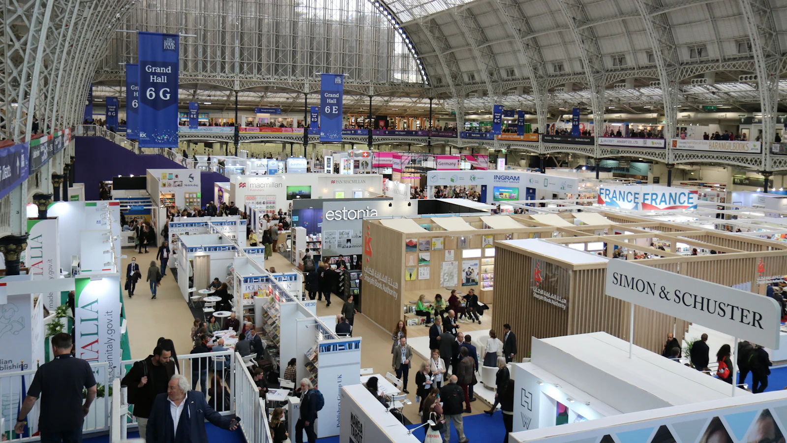 Busy exhibition hall with many booths and attendees