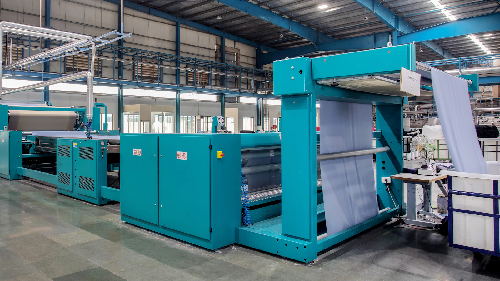 a large room with blue machines