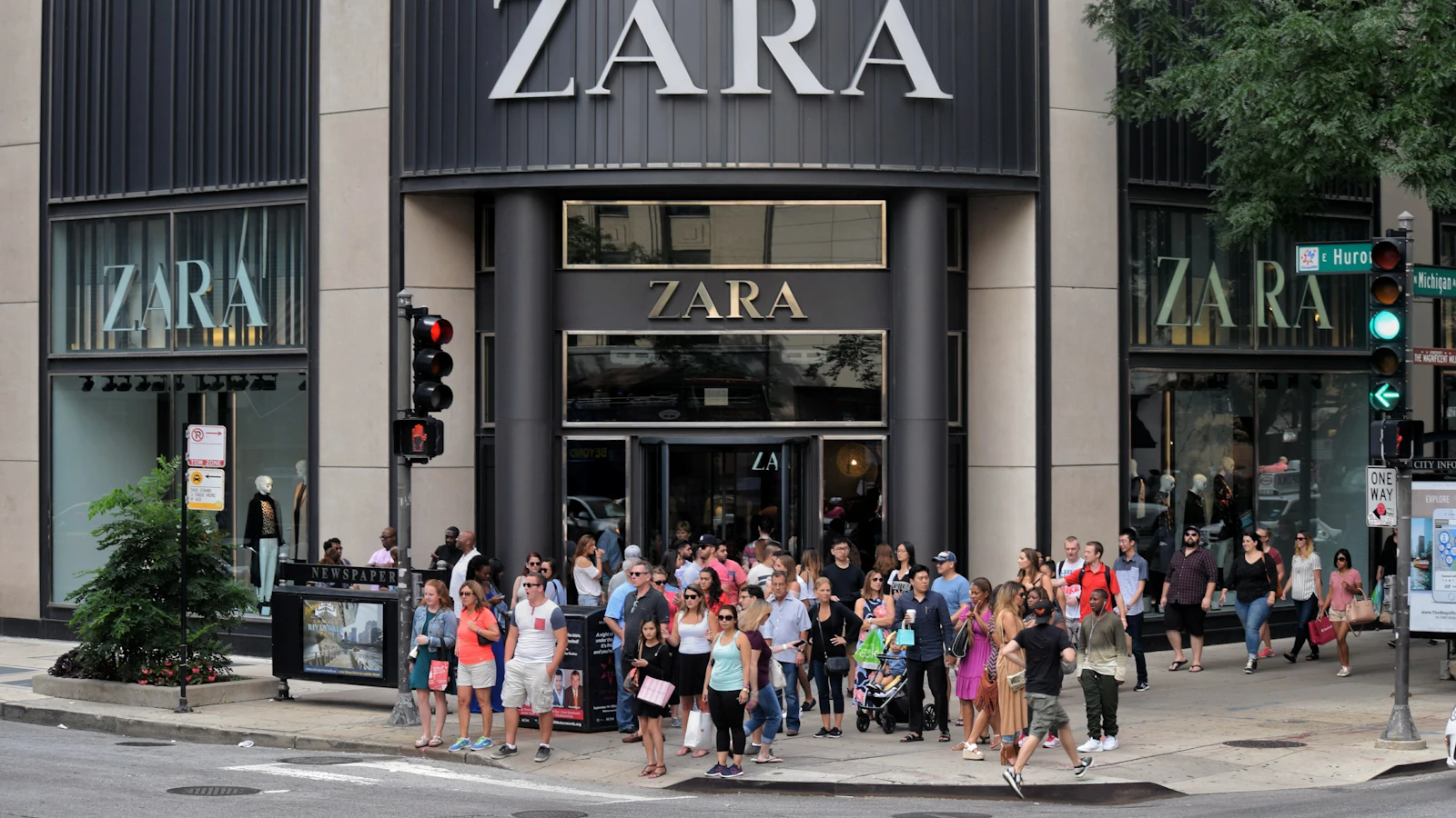 a group of people walking on the sidewalk