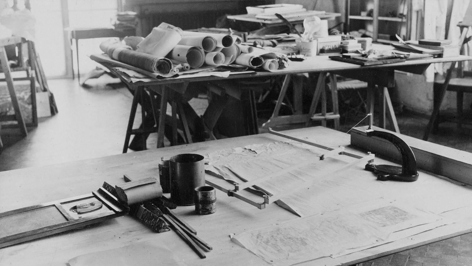 Architectural drafting table with blueprints and tools