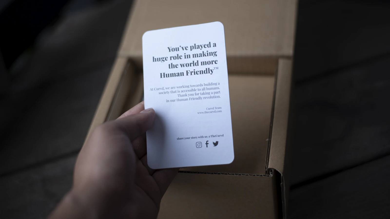 a person is holding a card in a box