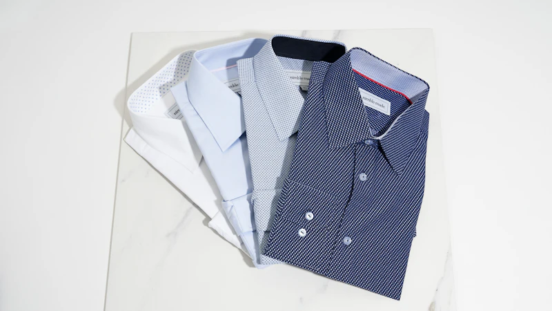 blue button up shirt on white table